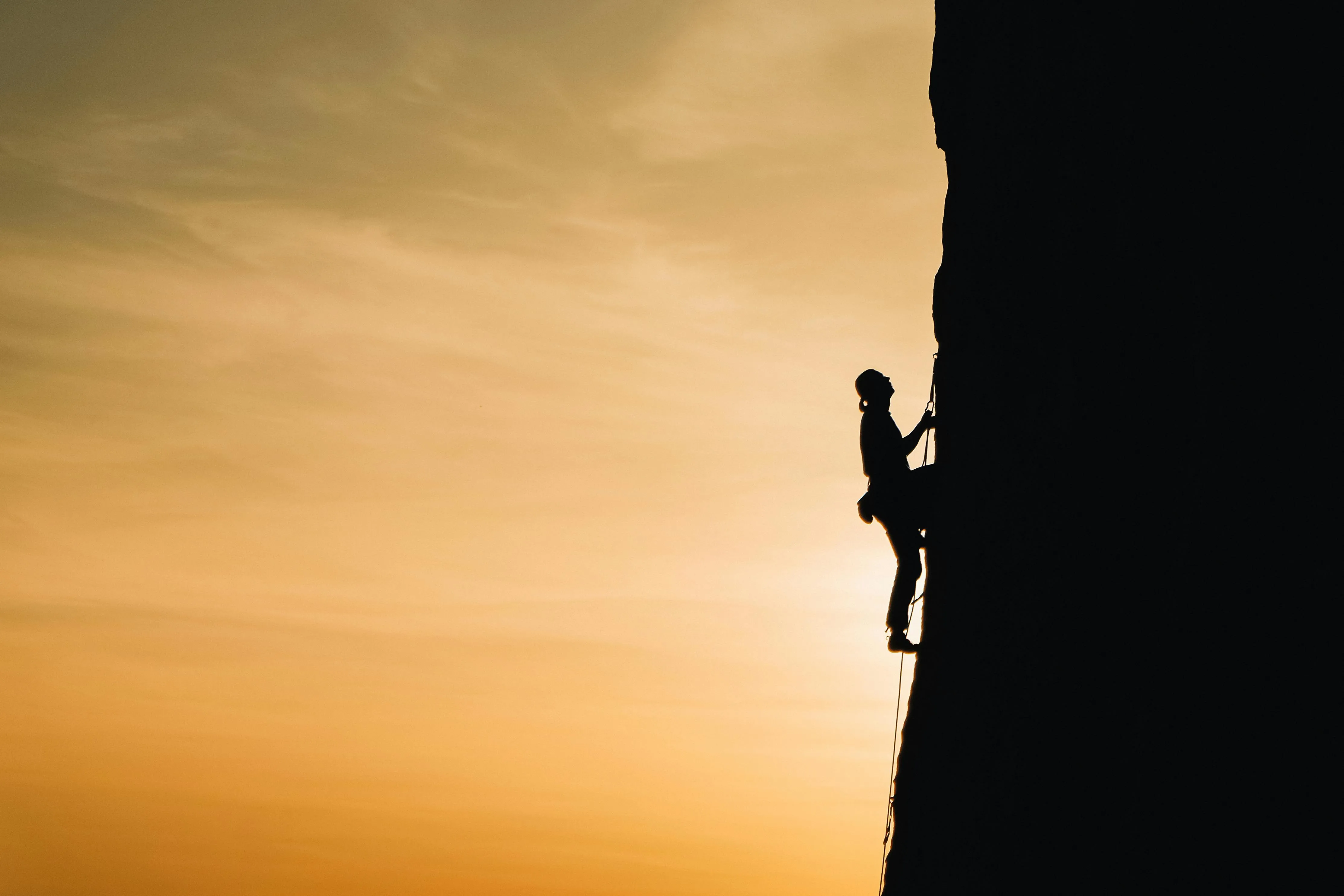 A climber climbing a mountain